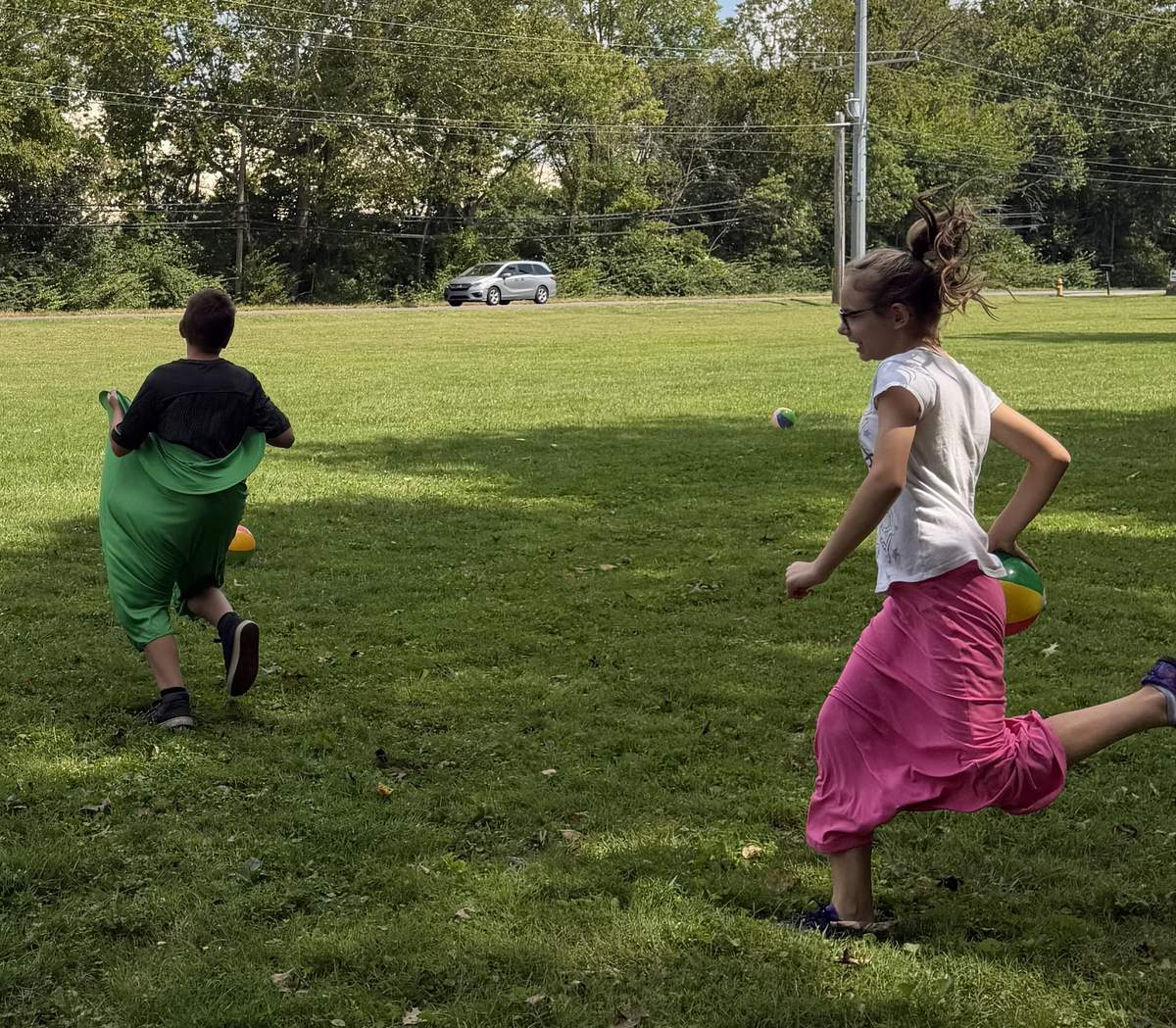 Children in colorful fabric costumes playing together outside