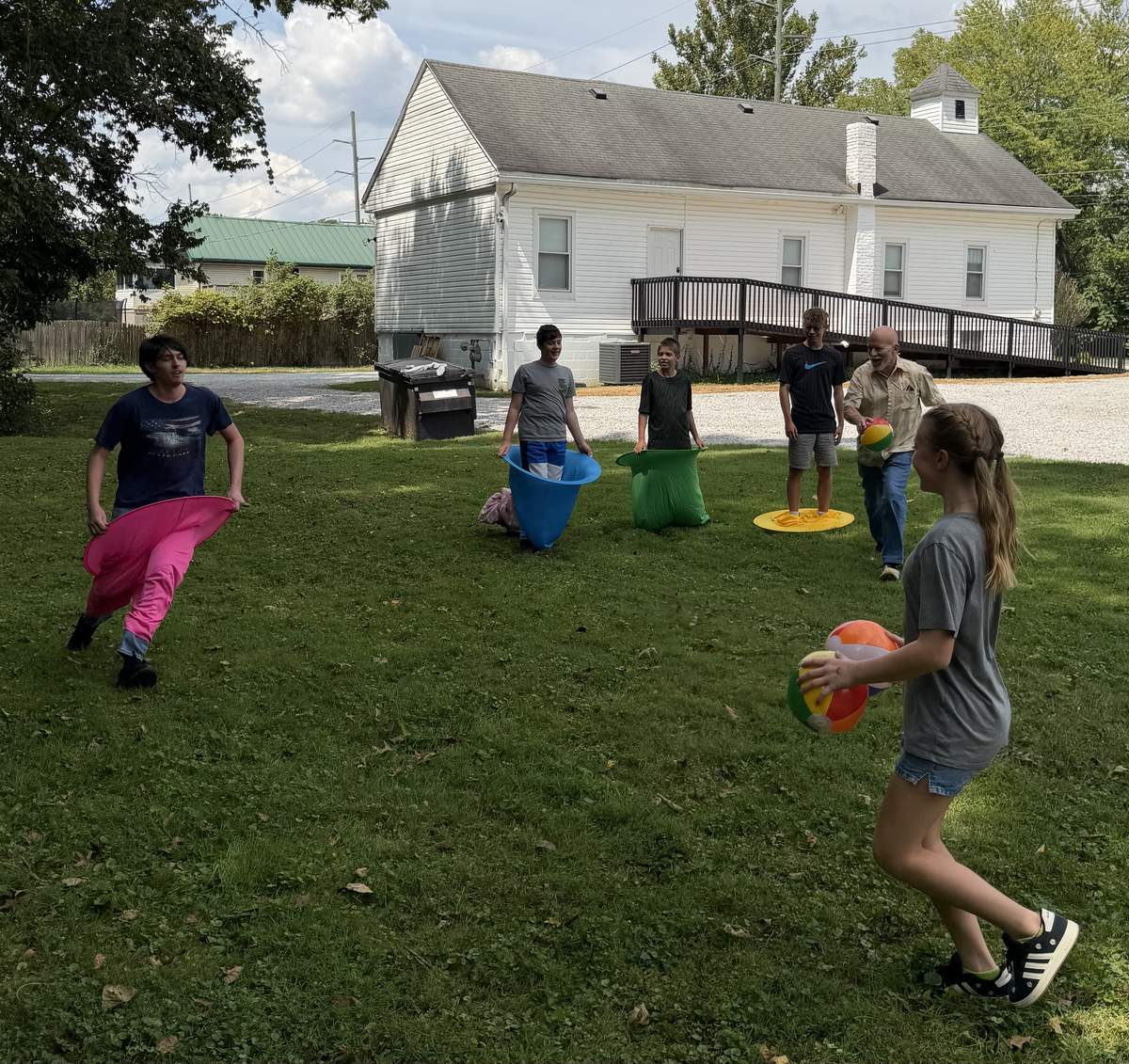 Children laughing while playing an outdoor kids ministry game