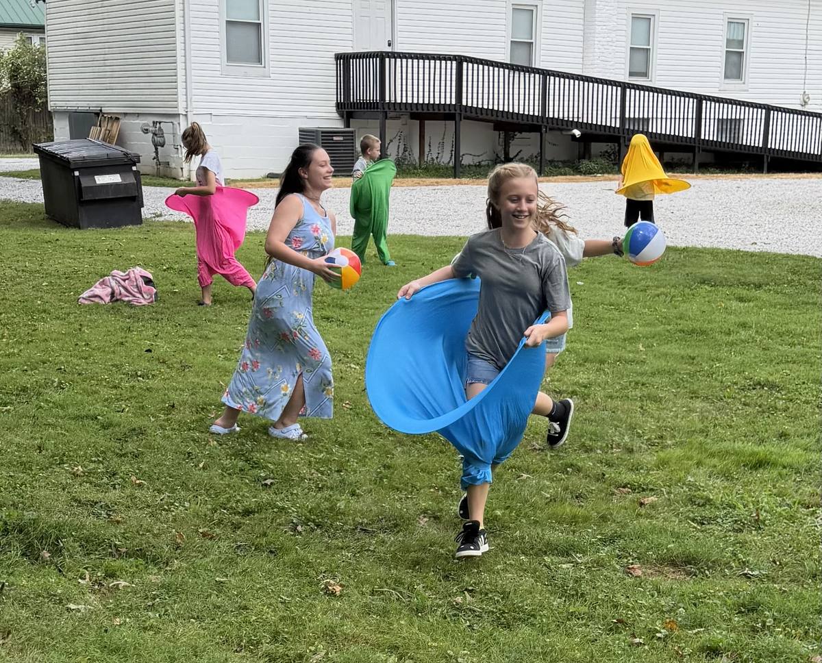 Children playing together outside during a kids ministry event