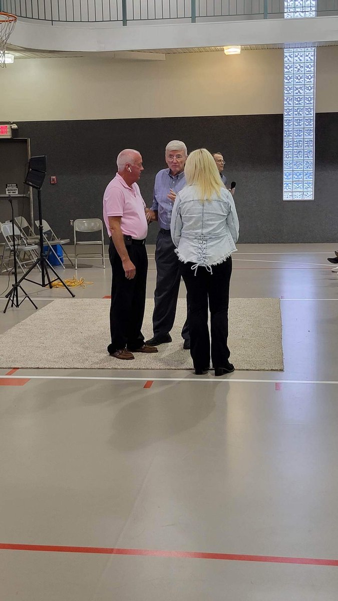 Church members standing together near the stage