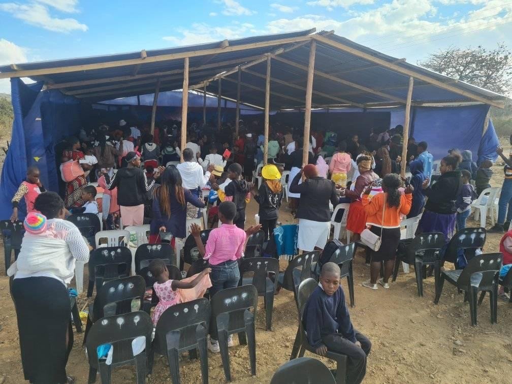 Crowded Karoi church congregation viewed from the back of the room