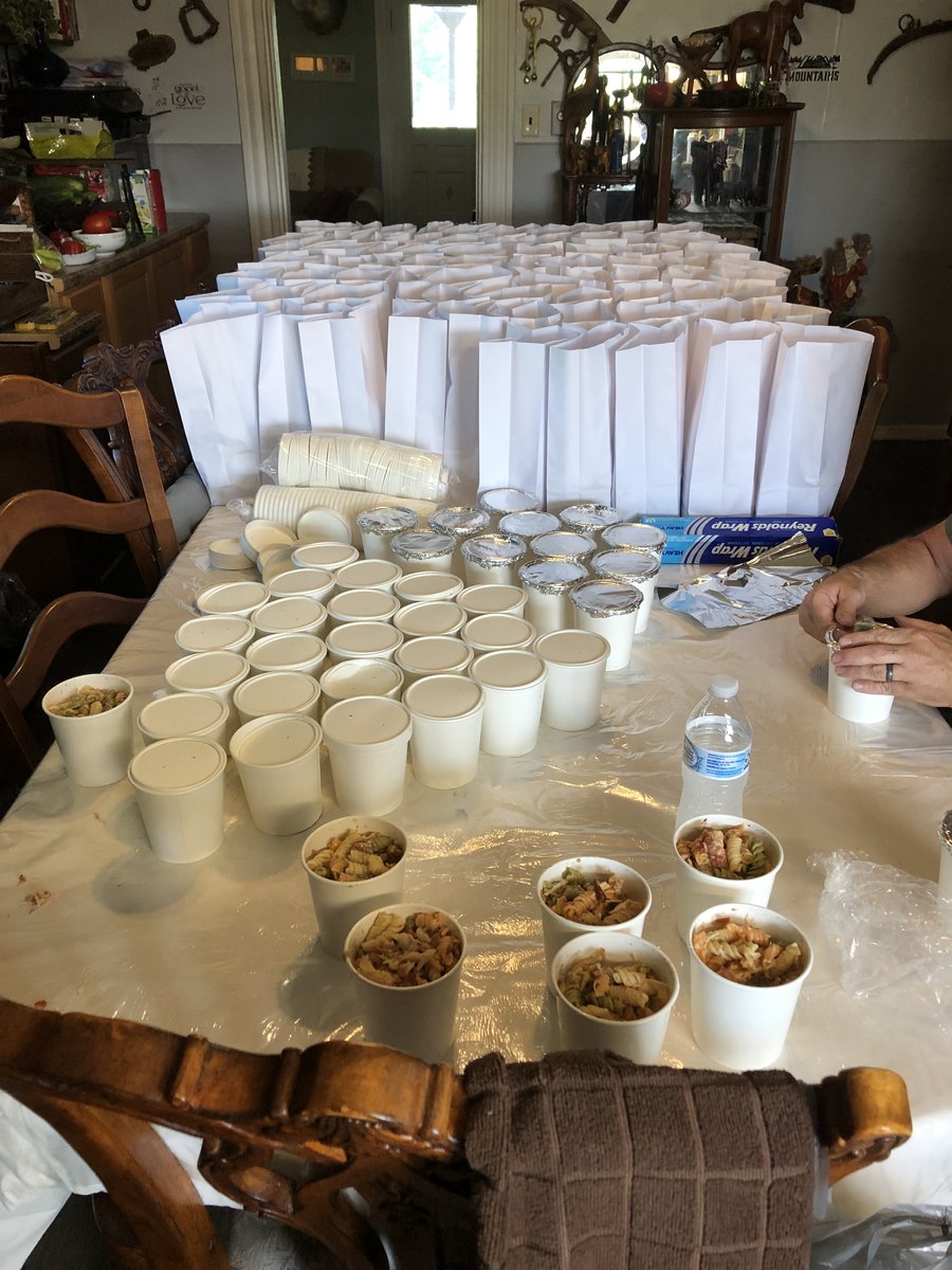Rows of prepared meal cups and bags lined up for street outreach