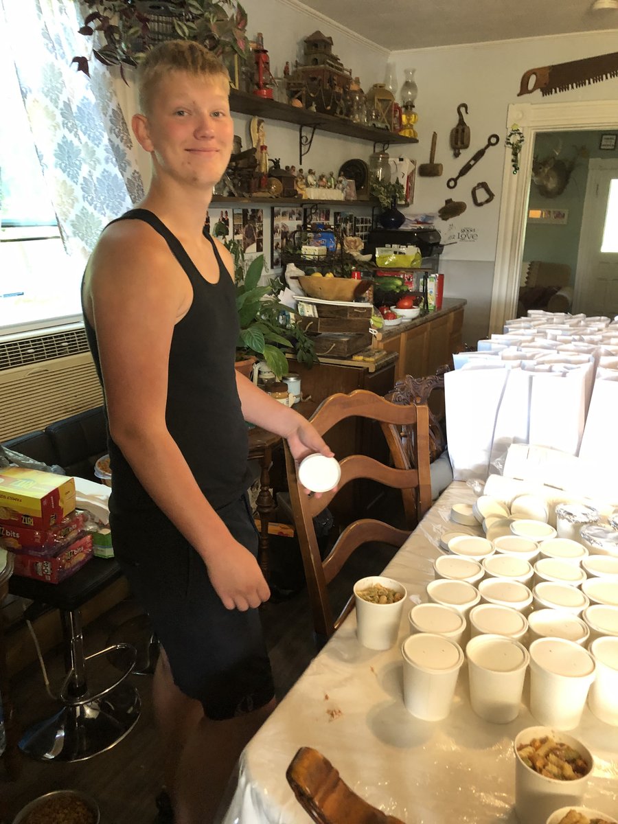 Volunteer packaging meal cups in the kitchen ahead of a street outreach run